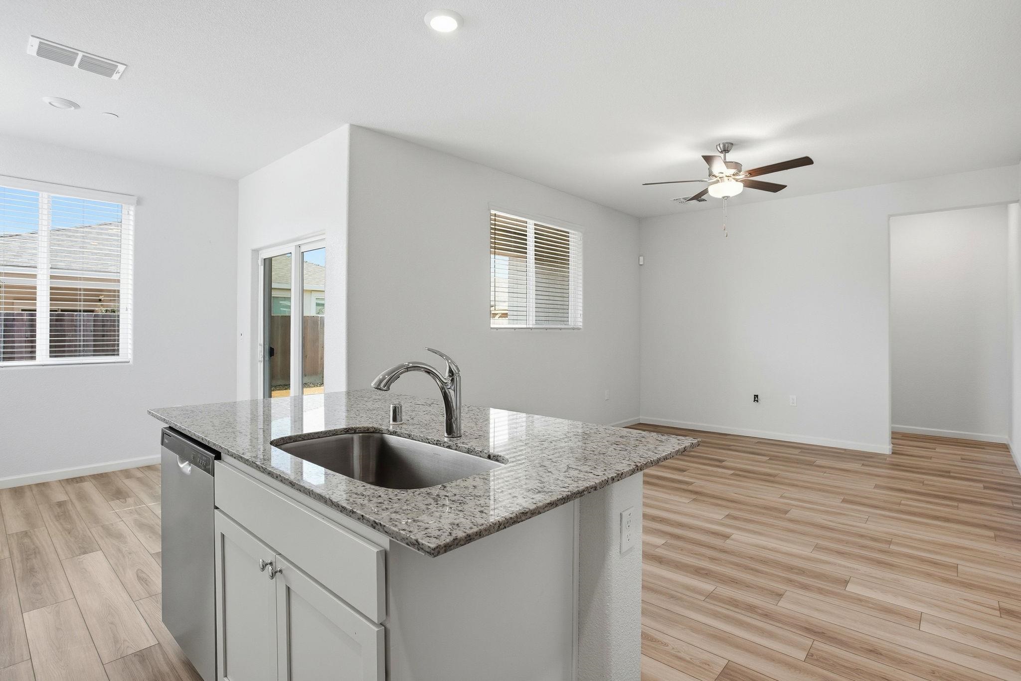 2055 Stars Drive Rio Vista, CA 94571 - Photo 6 of 43 a kitchen with sink granite and white cabinets