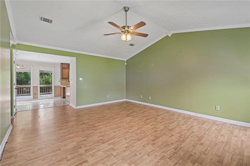 1318 Panhandle Way Hampton, GA 30228 - Photo 3 of 22 wooden floor in an empty room with a window