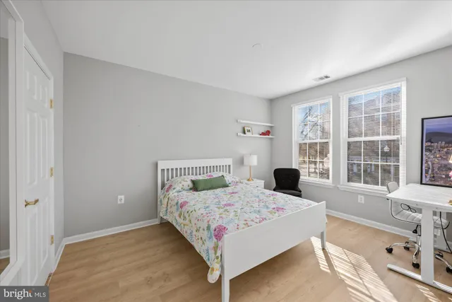 a bedroom with a bed and a large window