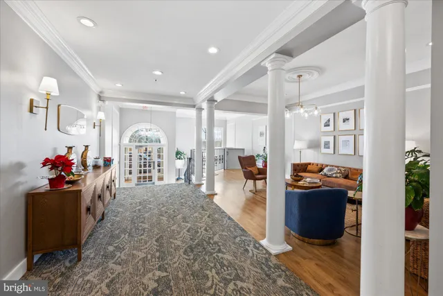a living room with furniture and a dining table with wooden floor