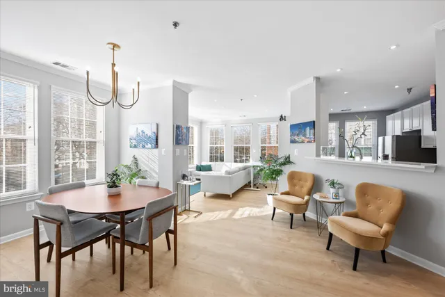 a living room with furniture a table and a chandelier