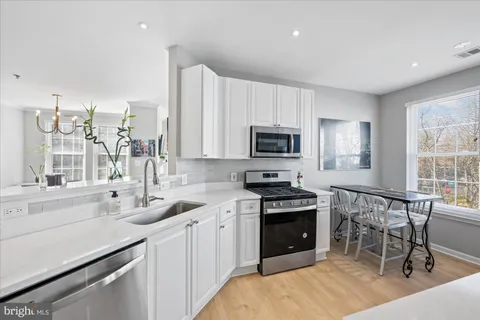 a dining room with furniture window and wooden floor