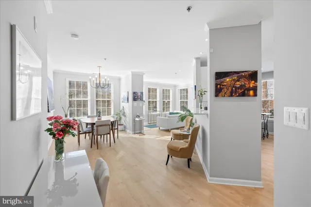 a living room with furniture and large windows