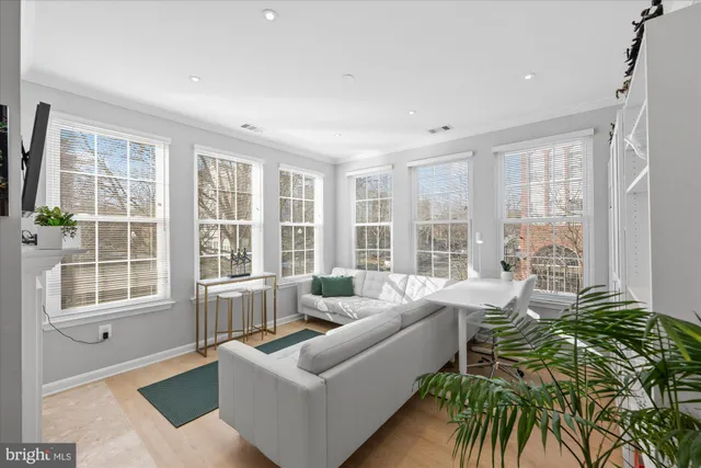 a kitchen with stainless steel appliances granite countertop white cabinets a sink stove and microwave