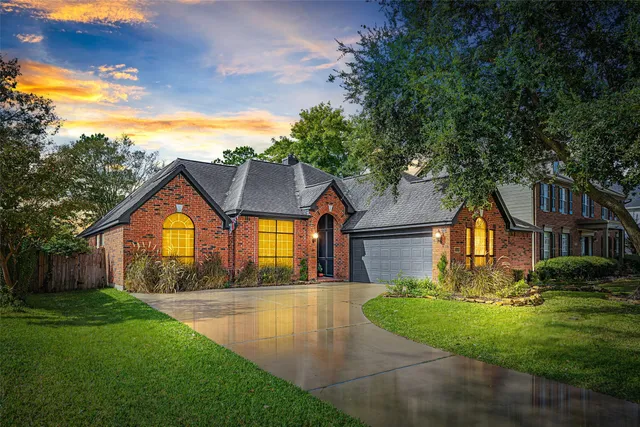 a front view of house with yard and green space