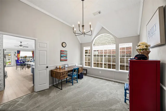 a dining room with wooden floor furniture and a chandelier