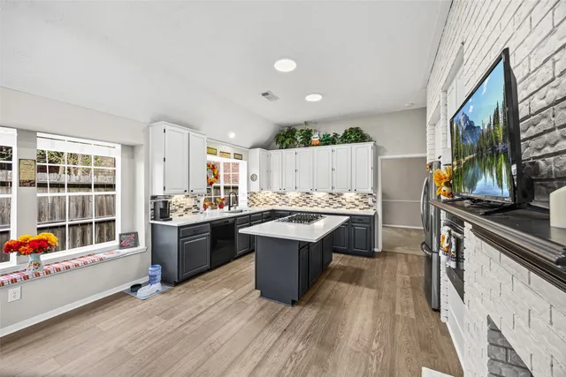 a kitchen with a sink stove and cabinets