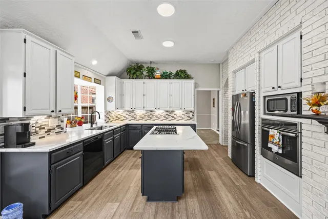 a kitchen with a sink stove and refrigerator