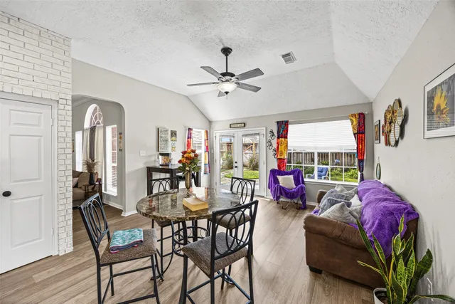 a living room with furniture a chandelier and a window