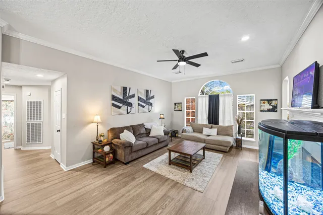 a living room with furniture and wooden floor