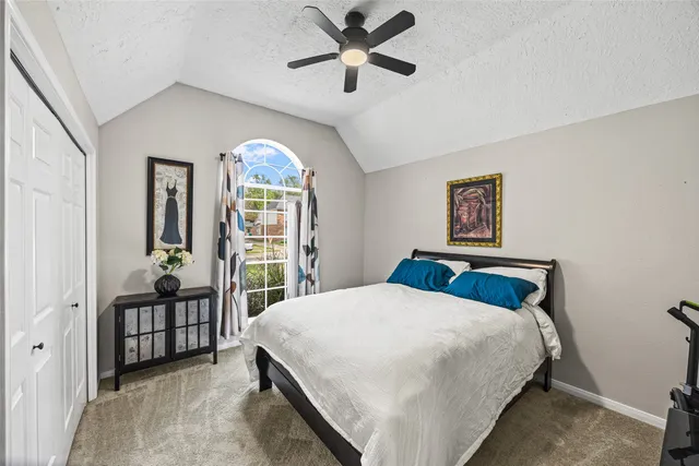 a bedroom with a balcony a bed and a chandelier