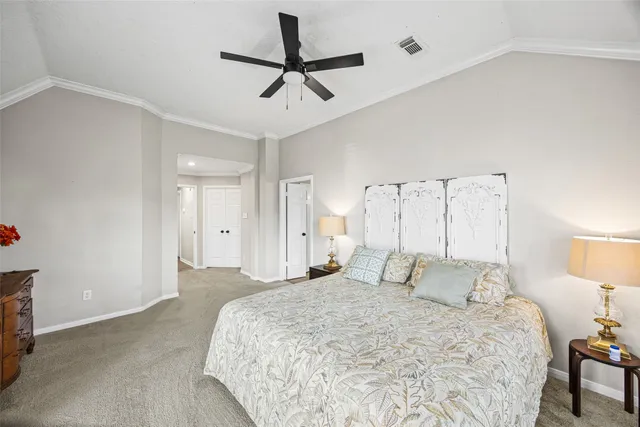 a bedroom with a bed and a lamp