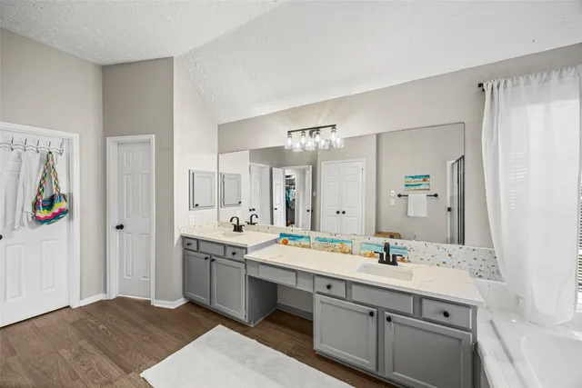 a bathroom with a double vanity sink mirror and double