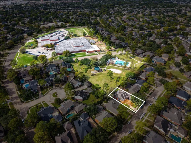 an aerial view of a house with a yard