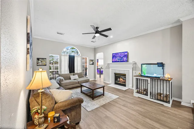 a living room with furniture a fireplace and a chandelier