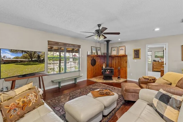 a living room with furniture a ceiling fan and a rug