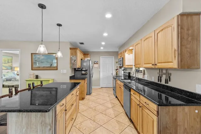 a kitchen with granite countertop a sink and a stove