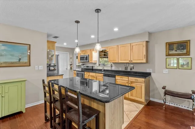 a kitchen with granite countertop a stove and a sink