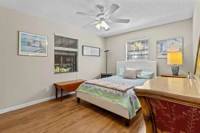 a bedroom with a bed a table and a chandelier