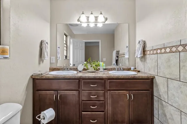 a front view of a house with a tree