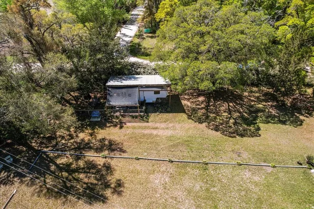 a view of yard with swimming pool and trees