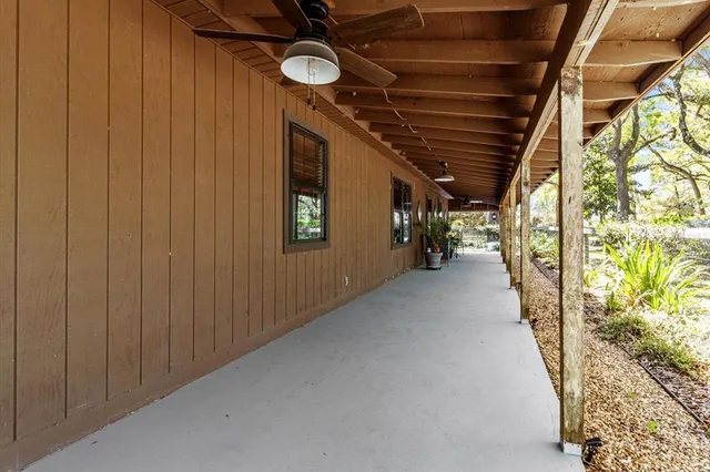 a view of a porch with chairs and backyard