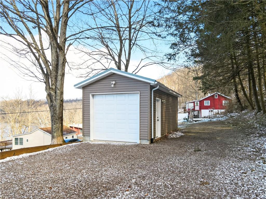 447 Lake Road Addison, PA 15411 - Photo 12 of 47 a front view of a house with a yard and garage