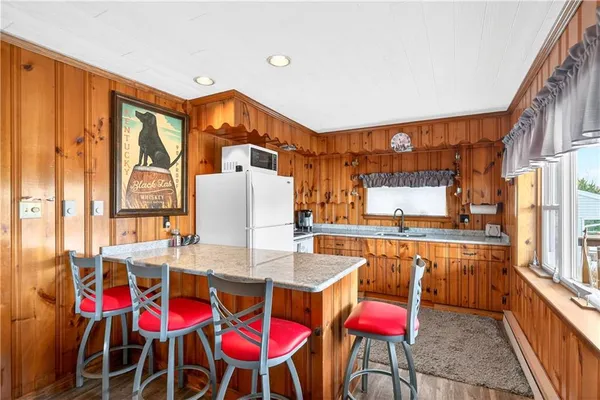 a kitchen with stainless steel appliances granite countertop a refrigerator and a sink