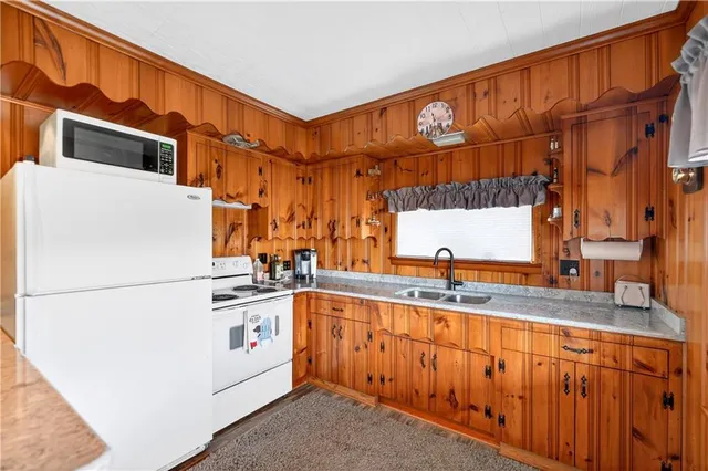 a kitchen with stainless steel appliances granite countertop a sink and a cabinets