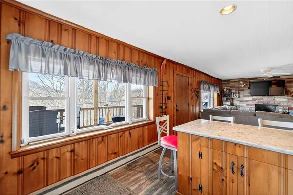 a kitchen with a table chairs and a refrigerator
