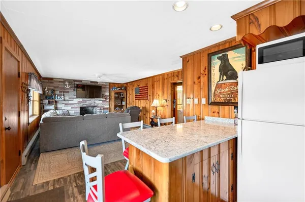 a living room with fireplace furniture and a large window
