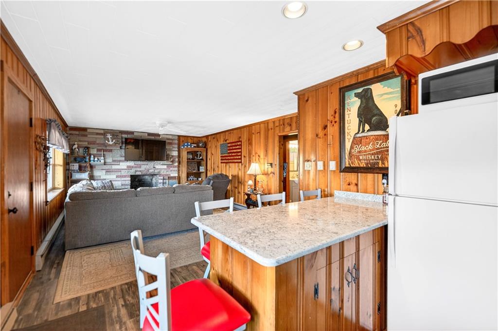 447 Lake Road Addison, PA 15411 - Photo 31 of 47 a kitchen with a table chairs and a refrigerator