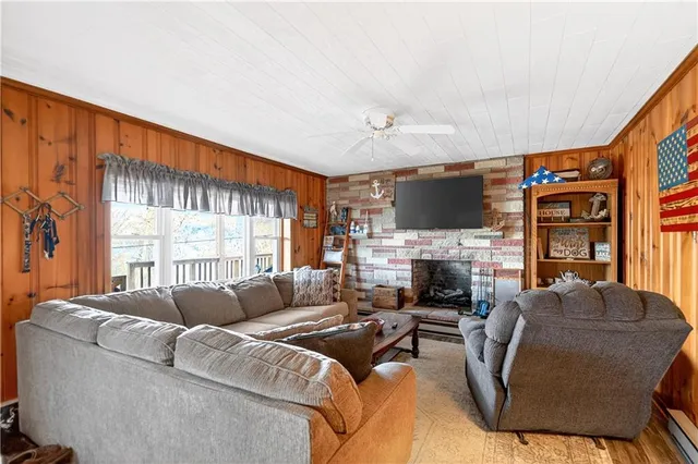 a living room with furniture fireplace and flat screen tv
