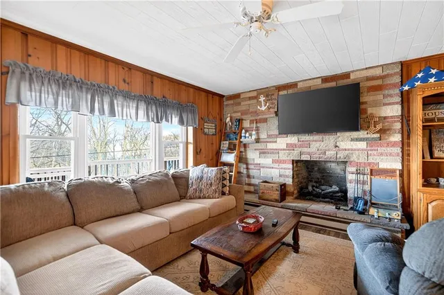 a living room with furniture a fireplace and a flat screen tv