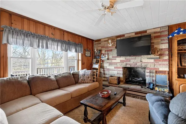 a living room with furniture a ceiling fan and a window