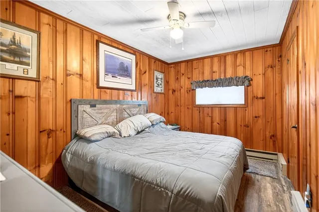 a bedroom with a large bed and a chandelier