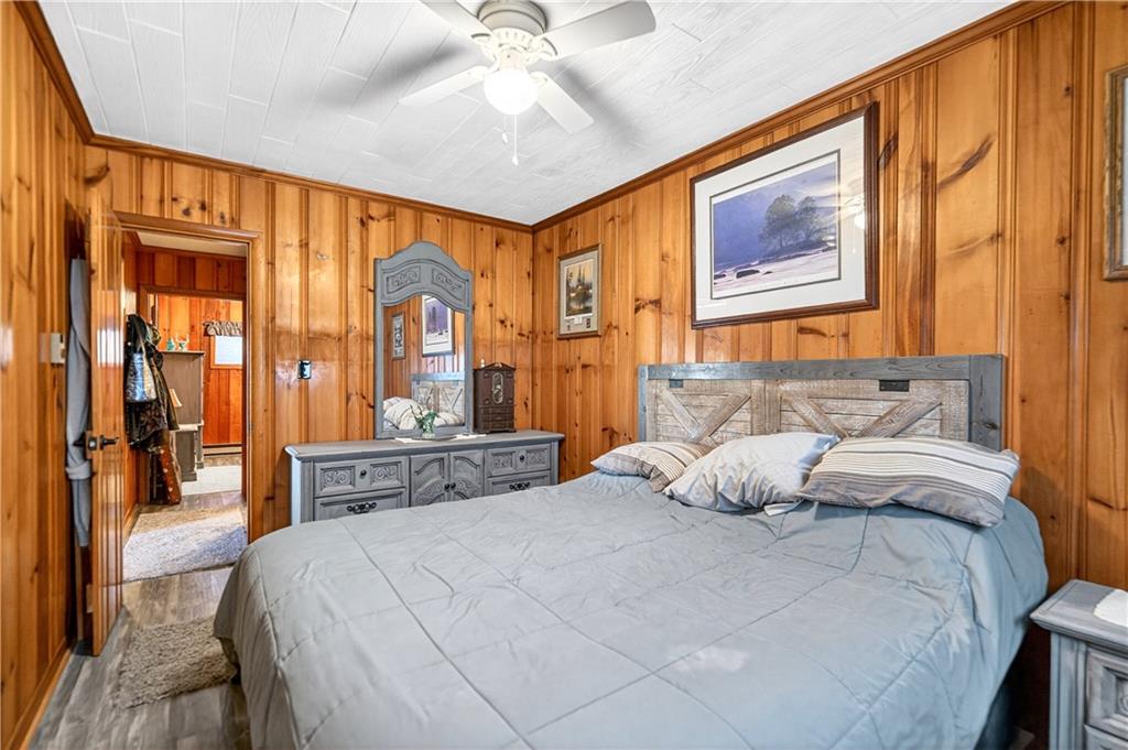 447 Lake Road Addison, PA 15411 - Photo 44 of 47 a bedroom with a large bed and a chandelier