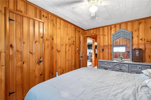 a bedroom with a bed and a chandelier