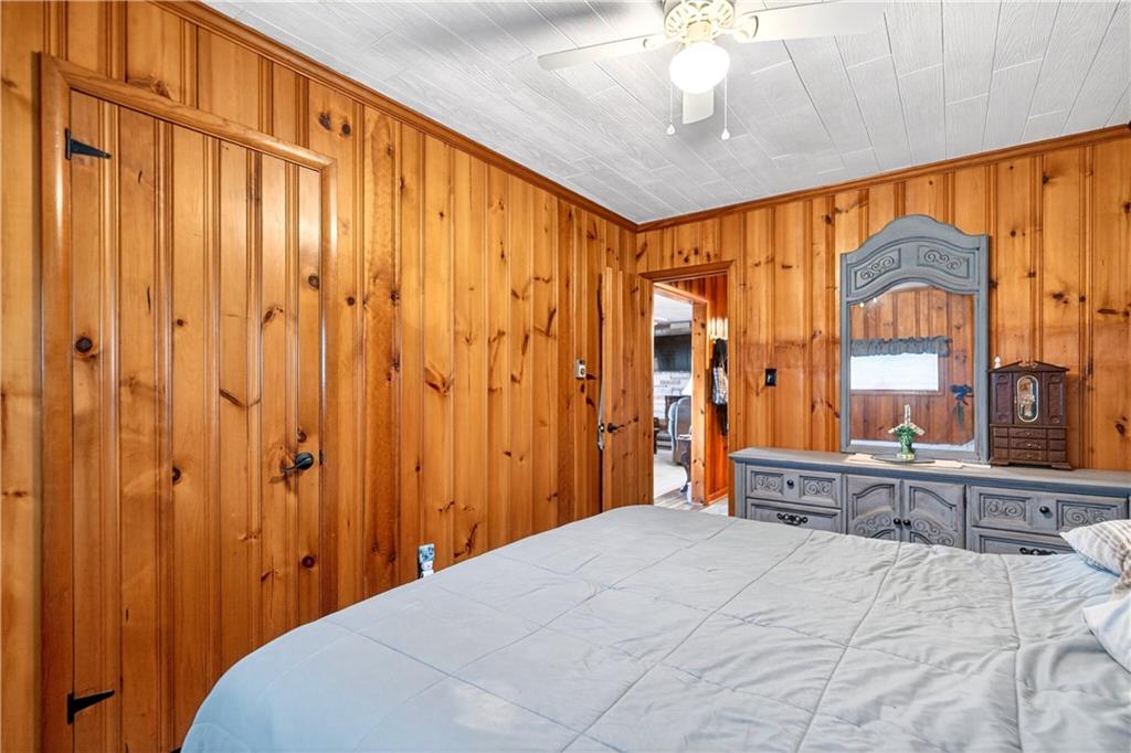 447 Lake Road Addison, PA 15411 - Photo 45 of 47 a bedroom with a bed and a chandelier