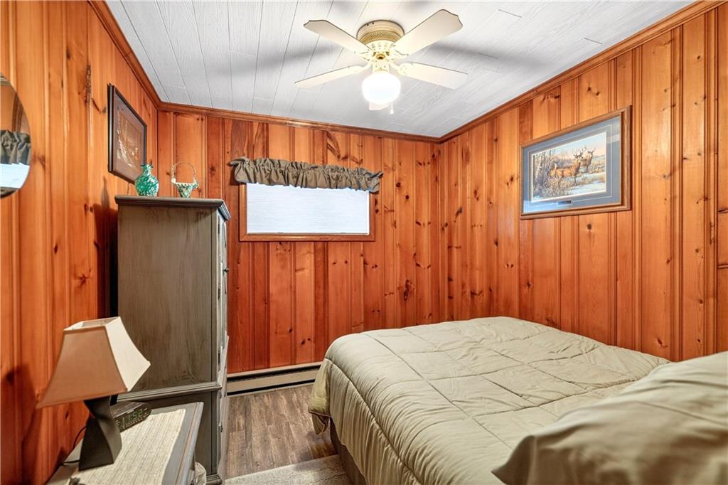 447 Lake Road Addison, PA 15411 - Photo 46 of 47 a bedroom with a bed and a chandelier