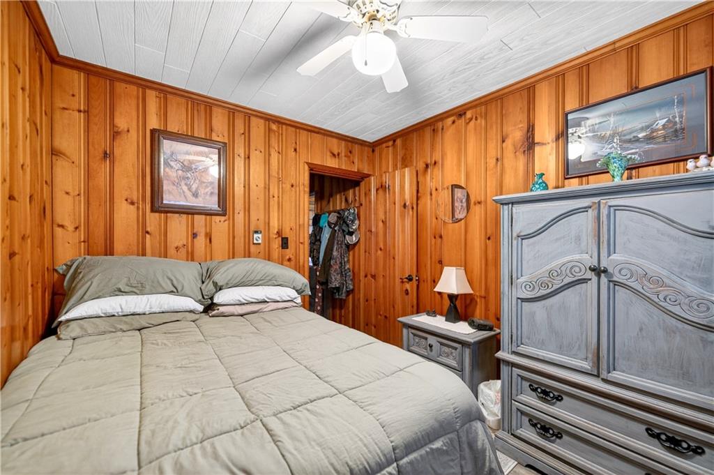 447 Lake Road Addison, PA 15411 - Photo 47 of 47 a bedroom with a bed and a chandelier