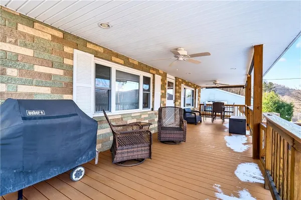 a view of a patio with dining table and chairs