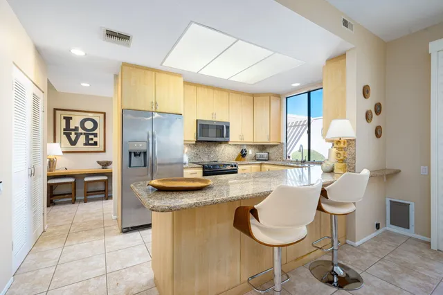 a kitchen with appliances cabinets and furniture