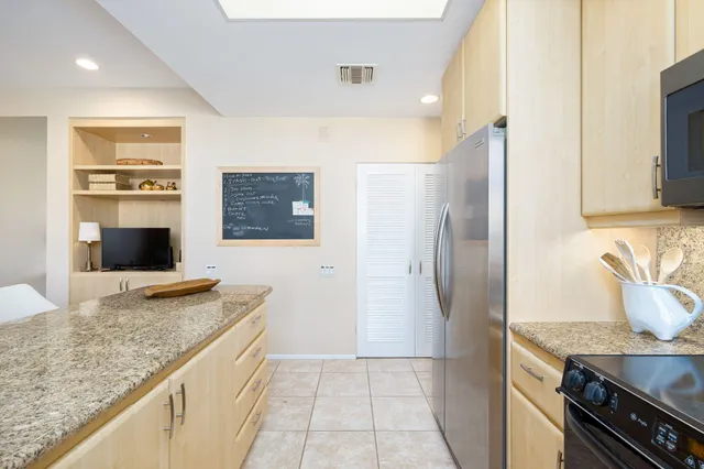 a view of a couches in patio with a yard