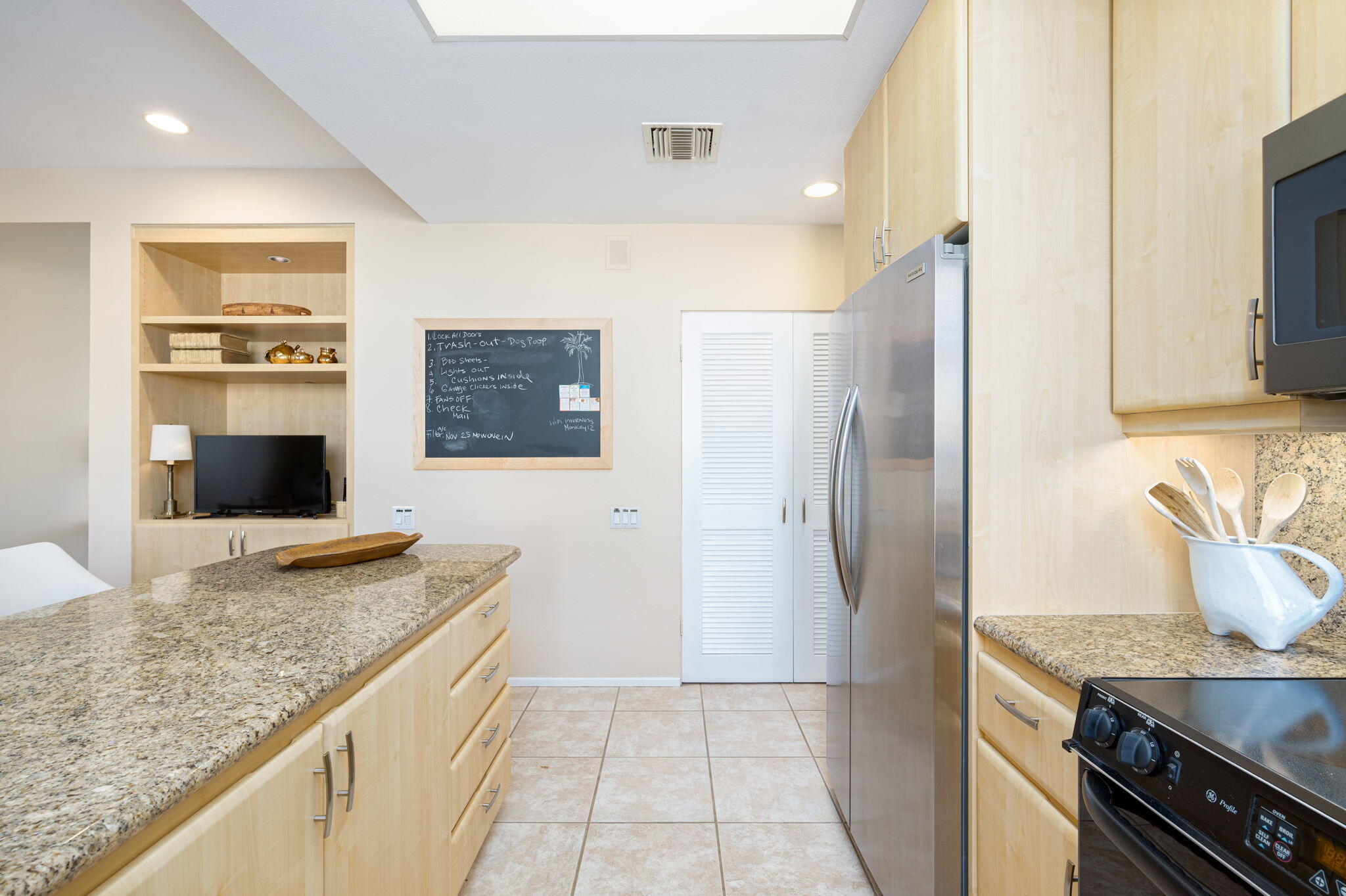 717 Inverness Drive Rancho Mirage, CA 92270 - Photo 16 of 46 a kitchen with stainless steel appliances granite countertop a refrigerator and a sink