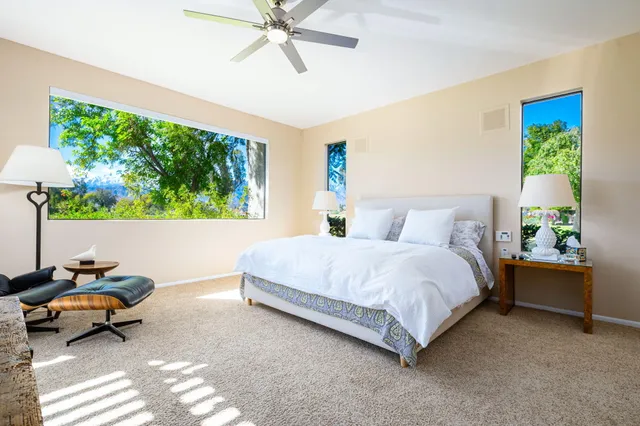 a bed room with a bed and a chair