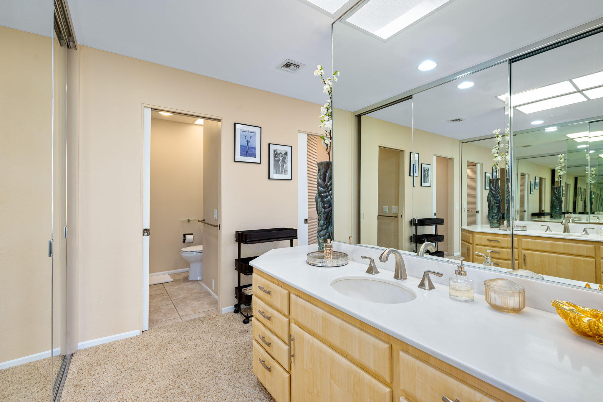 717 Inverness Drive Rancho Mirage, CA 92270 - Photo 20 of 46 a spacious bathroom with a granite countertop sink mirror and a bath tub