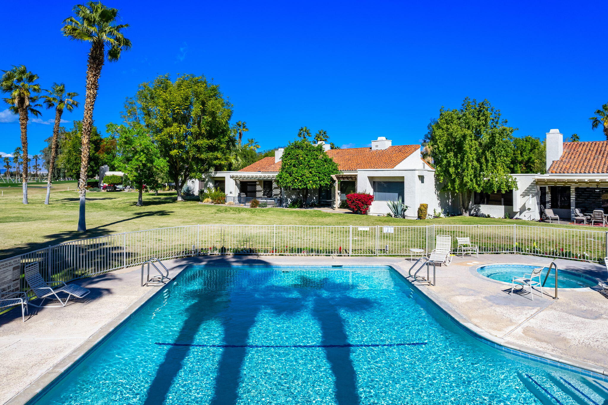 717 Inverness Drive Rancho Mirage, CA 92270 - Photo 27 of 46 a view of yard with swimming pool and table and chairs