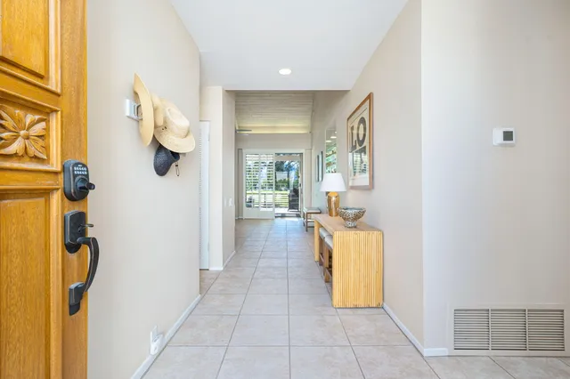 a living room with furniture and large windows