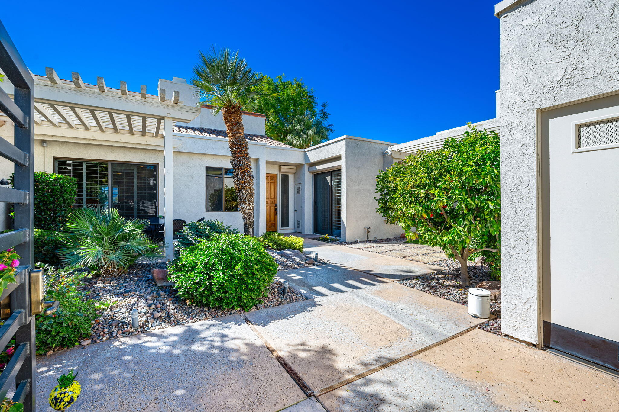717 Inverness Drive Rancho Mirage, CA 92270 - Photo 32 of 46 a front view of a house with garden